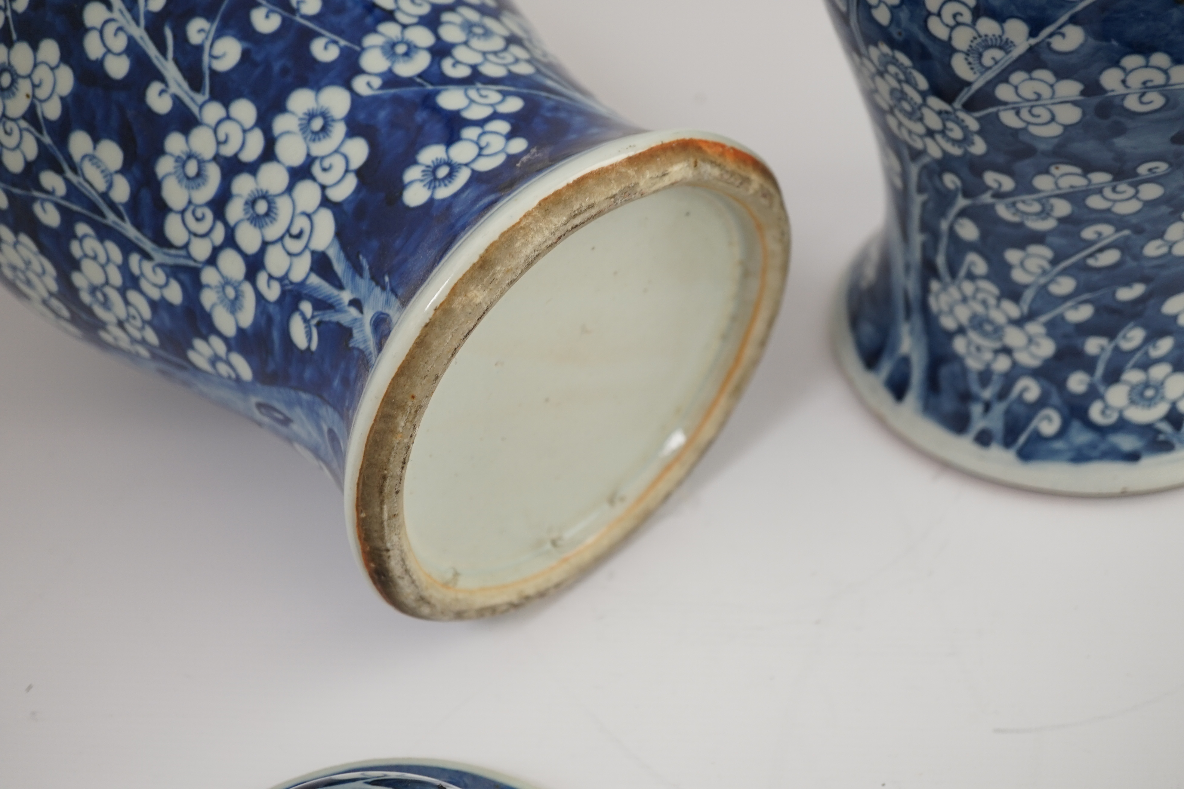 A pair of large Chinese blue and white ‘prunus’ baluster vases and covers, 19th century